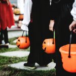 children trick or treating with pumpkin baskets