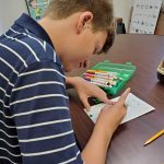 Student drawing a picture during therapy session