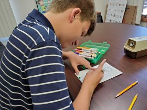 Student drawing a picture during therapy session