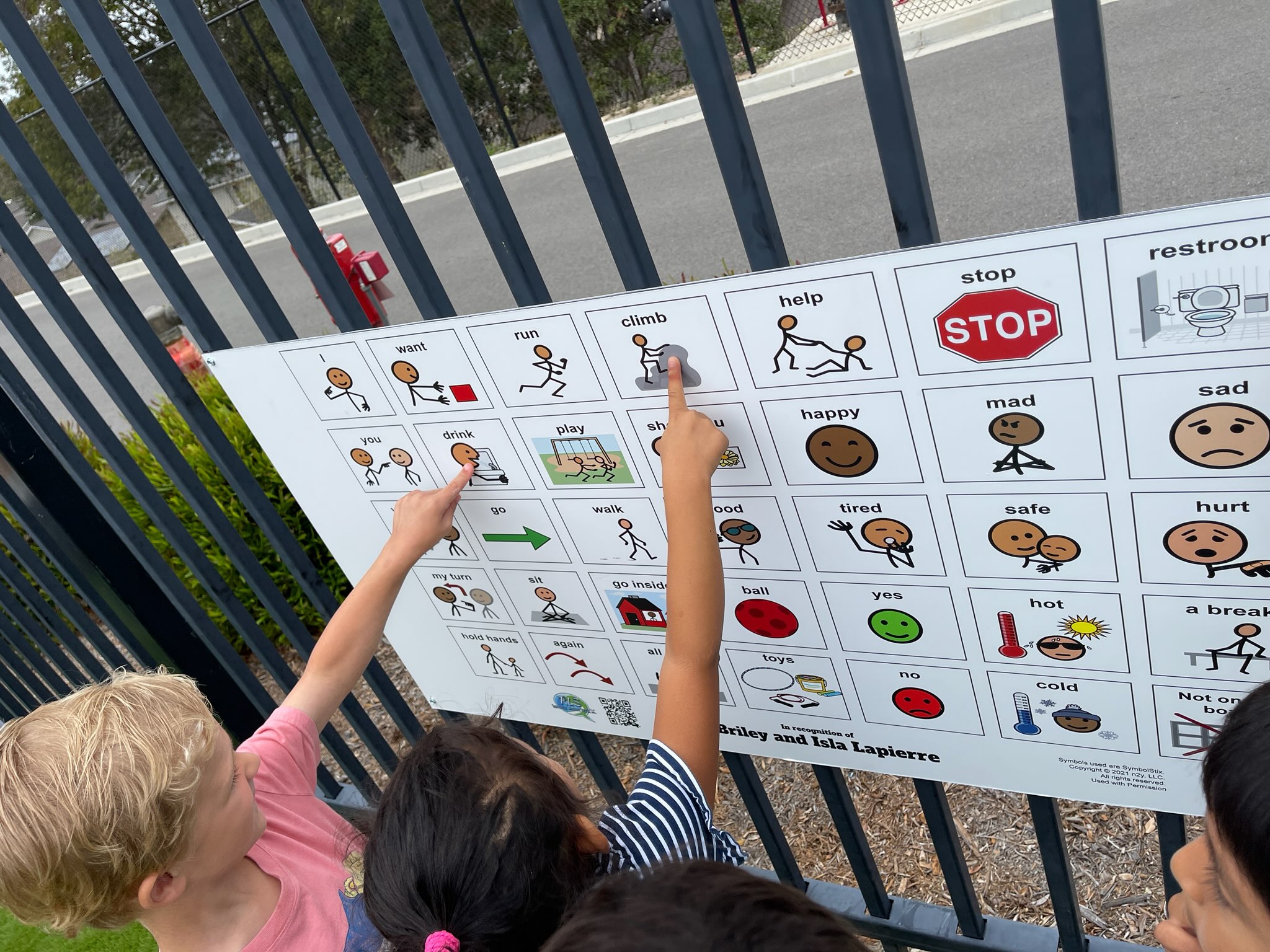 children using a playground communication sign