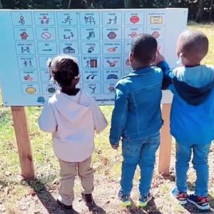 Students Using Customized Playground Communication Board  - Different Expectations Educational Services and Taahir's Village, Philadelphia, PA