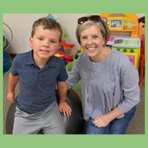 speech therapist and child smiling during therapy session