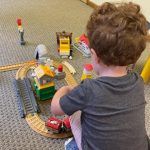 child in therapy playing with toy train