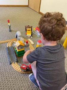 child in therapy playing with toy train