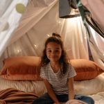 Child sitting in indoor tent