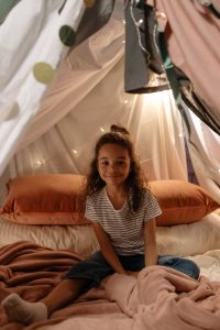 Child sitting in indoor tent