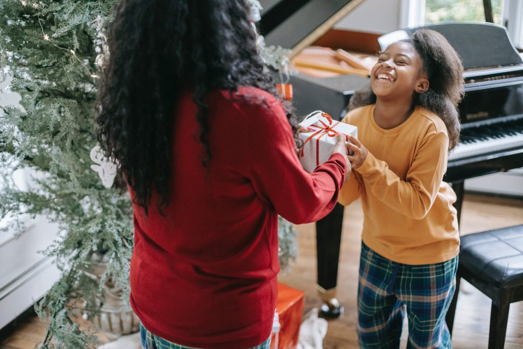 adult giving child a holiday gift