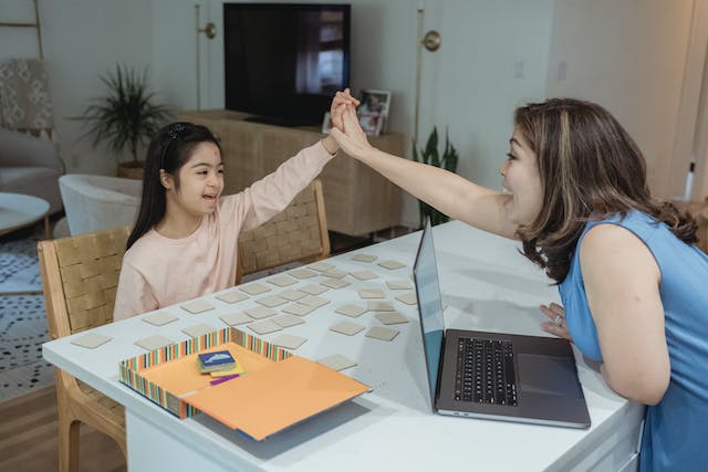 child giving high five to adult