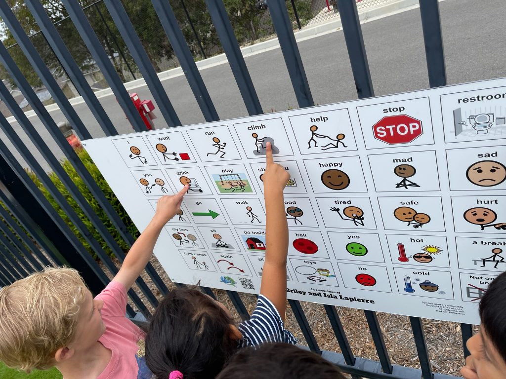 Children using Playground communication boards