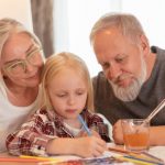 Grandparents working with child on an activity