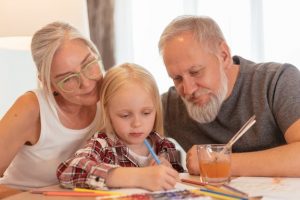 Grandparents working with child on an activity