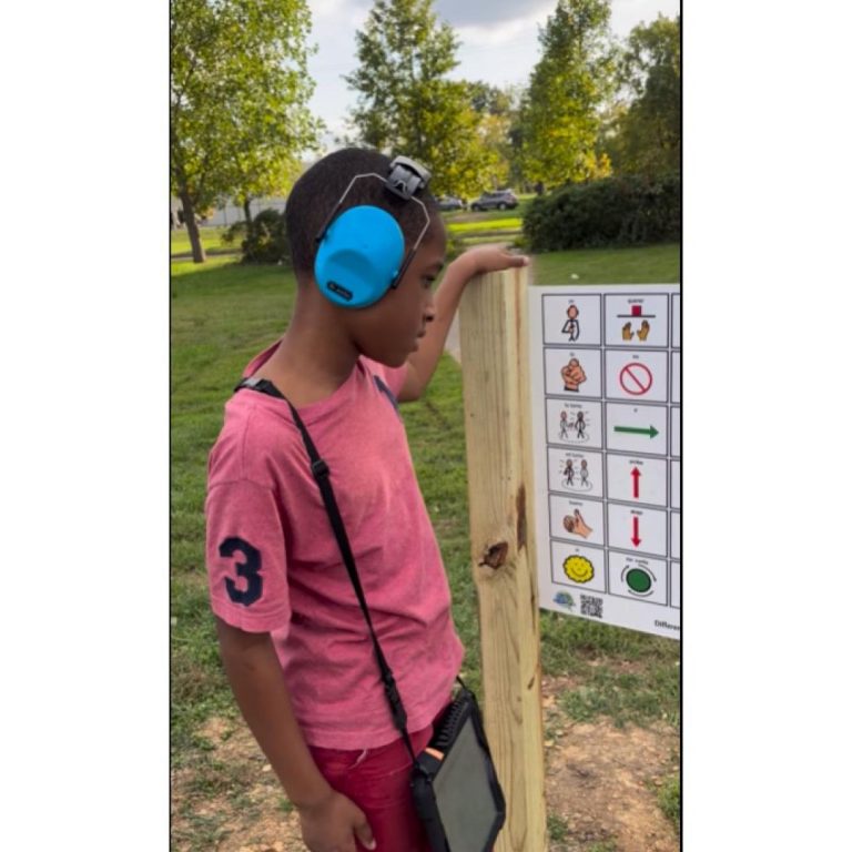 Communication board on a playgrouns. Student using it to communicate